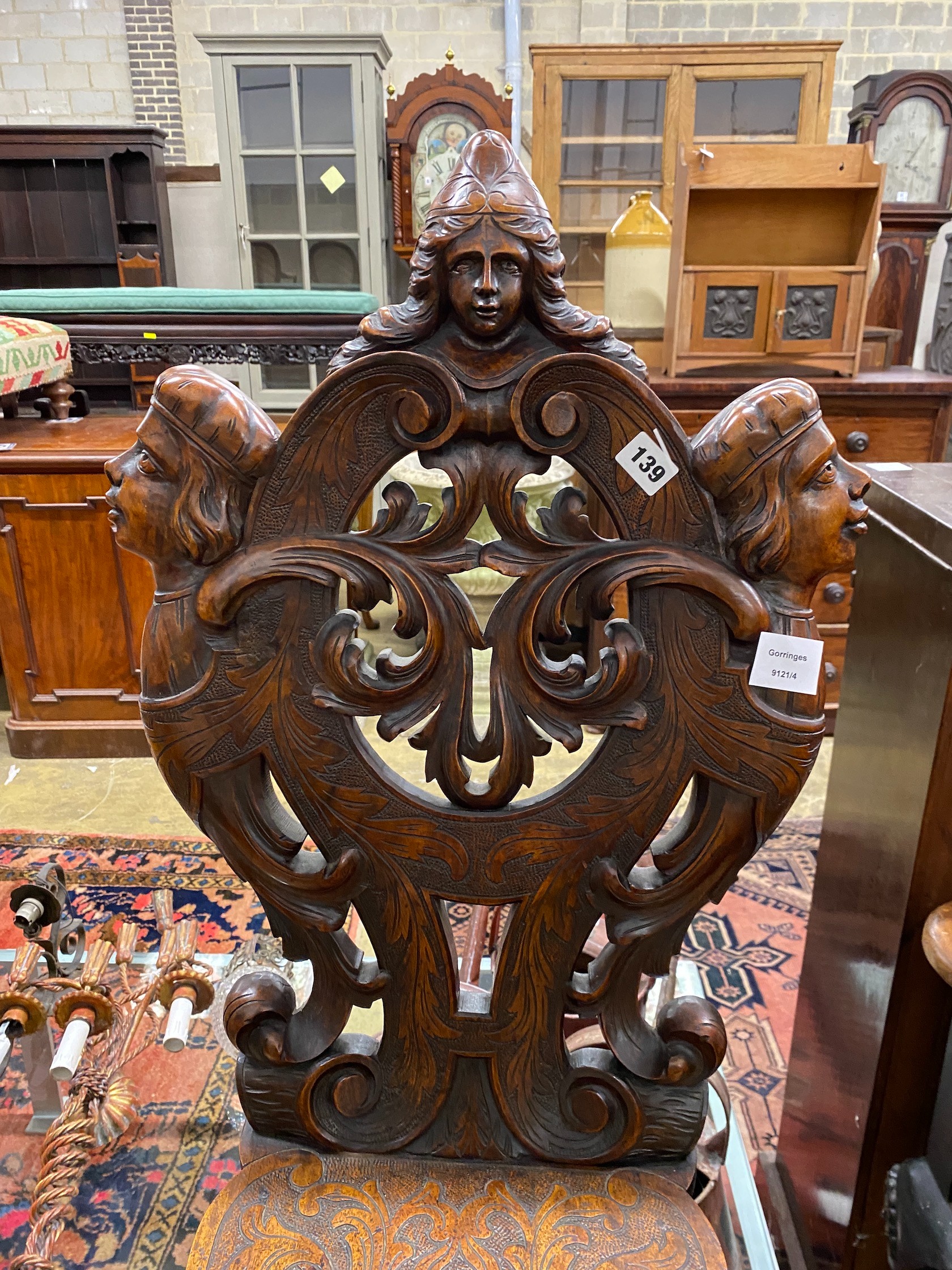 An early 20th century Italian carved walnut hall chair, height 108cm